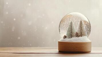 A snow globe with trees inside on a wooden table photo