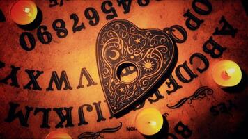 Witchcraft Spiritual Halloween Game Ouija Board in a Candle Light photo