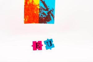 Flag of Ukraine with blood and puzzles with letters of Ukraine on a white back. As the symble of struggle photo