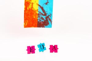 Flag of Ukraine with blood and puzzles with letters of Ukraine on a white back. As the symble of struggle photo