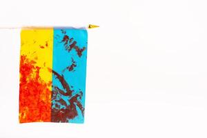 Flag of Ukraine with blood on a white background, top view. As the symble of struggle for the independence of the people photo