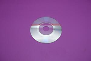 a compact disc isolated on purple background photo