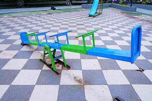 seesaw that can be played by 4 children. seesaw with a combination of blue and green colors. photo