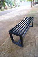 black bench made of iron. a bench with gaps in the seat photo