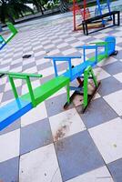 seesaw that can be played by 4 children. seesaw with a combination of blue and green colors. photo