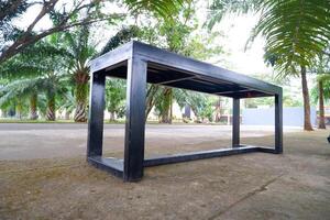 black bench made of iron. a bench with gaps in the seat photo