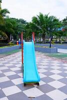 blue slide with iron stairs for children to play in the park photo