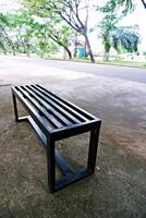 black bench made of iron. a bench with gaps in the seat photo