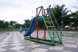 blue slide with iron stairs for children to play in the park photo