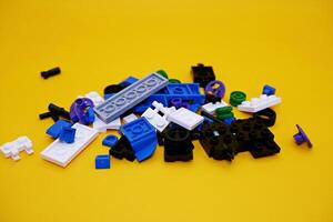 A collection of toy blocks isolated on a yellow background. Toys that are played by stacking them like stacking bricks. photo