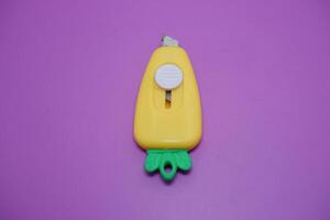cute mini cutter with carrot shape. cute cutter isolated on purple background. photo
