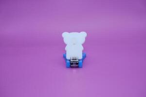 cute nail clippers isolated on purple background. cute nail clippers with blue and white color combination photo