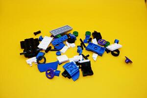 A collection of toy blocks isolated on a yellow background. Toys that are played by stacking them like stacking bricks. photo
