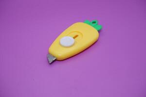 cute mini cutter with carrot shape. cute cutter isolated on purple background. photo
