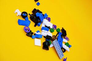 A collection of toy blocks isolated on a yellow background. Toys that are played by stacking them like stacking bricks. photo