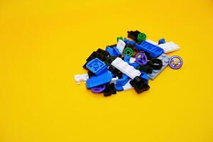 A collection of toy blocks isolated on a yellow background. Toys that are played by stacking them like stacking bricks. photo