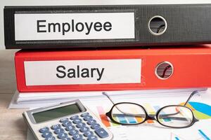 Payroll overtime. Binder data finance report business with graph analysis in office. photo