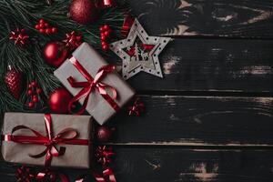 Top view photo Christmass flatlay gift boxes,red christmas tree toys and spruce brance on wooden background. Xmas backdrop with space for text.Copyspace.