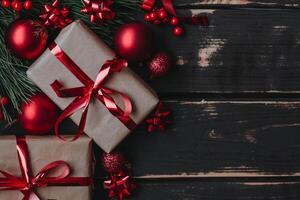Top view photo Christmass flatlay gift boxes,red christmas tree toys and spruce brance on wooden background. Xmas backdrop with space for text.Copyspace.