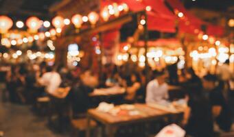 Abstract blur people at night food market background. Vintage effect style photo