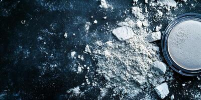 Scattered powder on a dark background creating a textured abstract pattern photo
