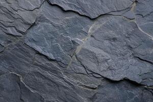 A rugged slate texture with natural grooves and subtle variations in tone photo