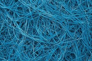 A tangled web of blue wires creates a dynamic, futuristic background photo