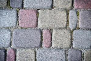 The surface of the sidewalk. Detailed texture of a stone pedestrian walkway. Top view. photo
