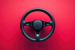 The focus is on a sleek and modern steering wheel, showcasing its minimalist design against a striking red backdrop, highlighting form and function. photo