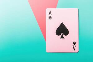The ace of spades card is prominently displayed on a clean, colorful background featuring geometric shapes. The bold design emphasizes the cards iconic symbol. photo