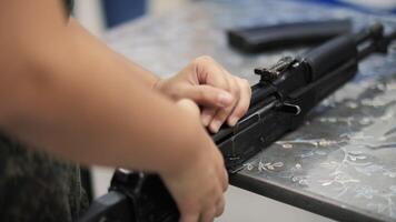 Close up of Soldier Disassembling Rifle on Table video