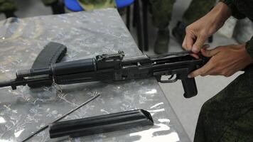 Soldier Assembling Assault Rifle on Table video