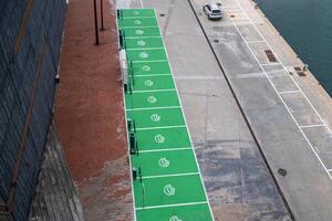Empty parking places with signage for charging electric cars. A view from above. photo