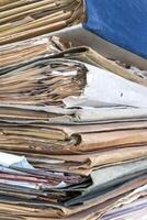 Old folders with documents in the library. Vertical view photo