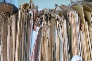 Old folders with documents in the library. Horizontal view photo