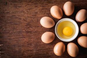 Yolk eggs for cooking in new recipe on tray at wooden background photo
