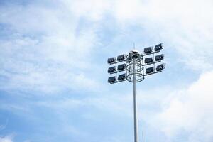 Bright Stadium Lights Against Blue Sky Background photo