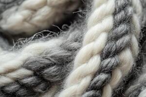 Close-up of intricately braided wool fibers in shades of gray and white on a textile background photo