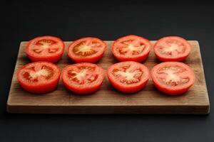 Freshly sliced tomatoes arranged on a wooden cutting board, showcasing vibrant red color and intricate seed patterns photo