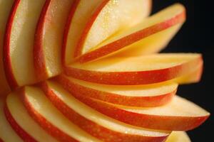 Sliced red apple showcasing vibrant colors and smooth textures against a dark background perfect for healthy eating or culinary presentations photo