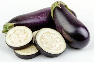 Freshly harvested eggplants displayed on a light background with sliced pieces showcasing the inner texture and color photo