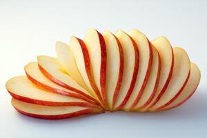 Freshly sliced red apples arranged artistically on a light background showcasing their juicy texture and vibrant color photo