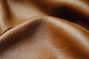 Detailed view of textured brown leather fabric draped softly on a flat surface photo