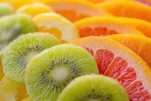 Colorful display of sliced citrus and kiwi fruit arranged in a vibrant pattern for a fresh snack photo