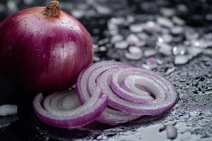 Fresh red onion with sliced rings on a dark wet countertop showcasing vibrant colors and textures of the produce photo