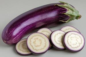 Freshly harvested eggplant cut into slices on a neutral background, highlighting vibrant colors and textures of the vegetable photo