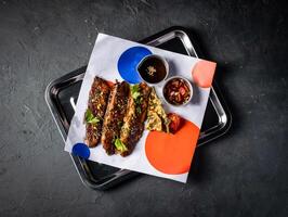 Hickory Bbq Beef Brisket Belly with Dipping Sauces served in tray isolated on grey background top view of A la carte Food platter photo