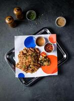 Spicy Grilled Jerk Chicken Slice with Sweet and Sour Sauce and tomato served in tray isolated on grey background top view of A la carte Food platter photo