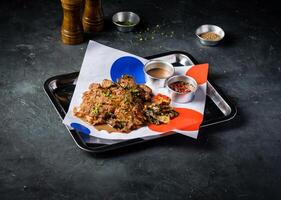 Spicy Grilled Jerk Chicken Slice with Sweet and Sour Sauce and tomato served in tray isolated on grey background side view of A la carte Food platter photo