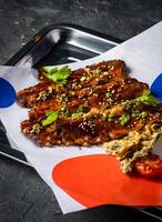 Hickory Bbq Beef Brisket Belly with Dipping Sauces and green onion served in tray isolated on grey background closeup side view of A la carte Food platter photo